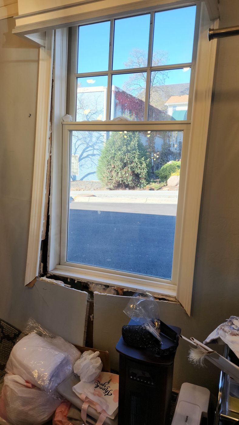 Window frame knocked loose from the inside