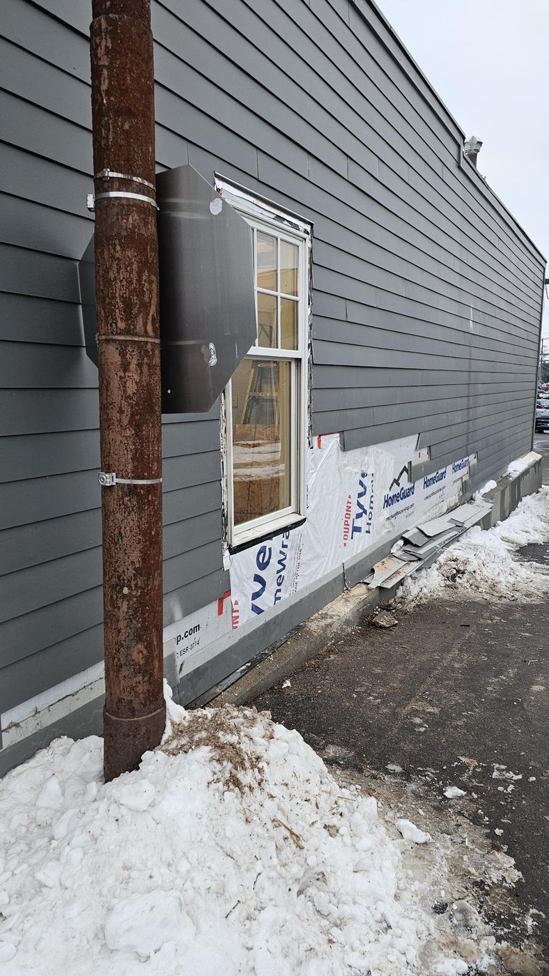 Window and lower-wall repair on a commercial building