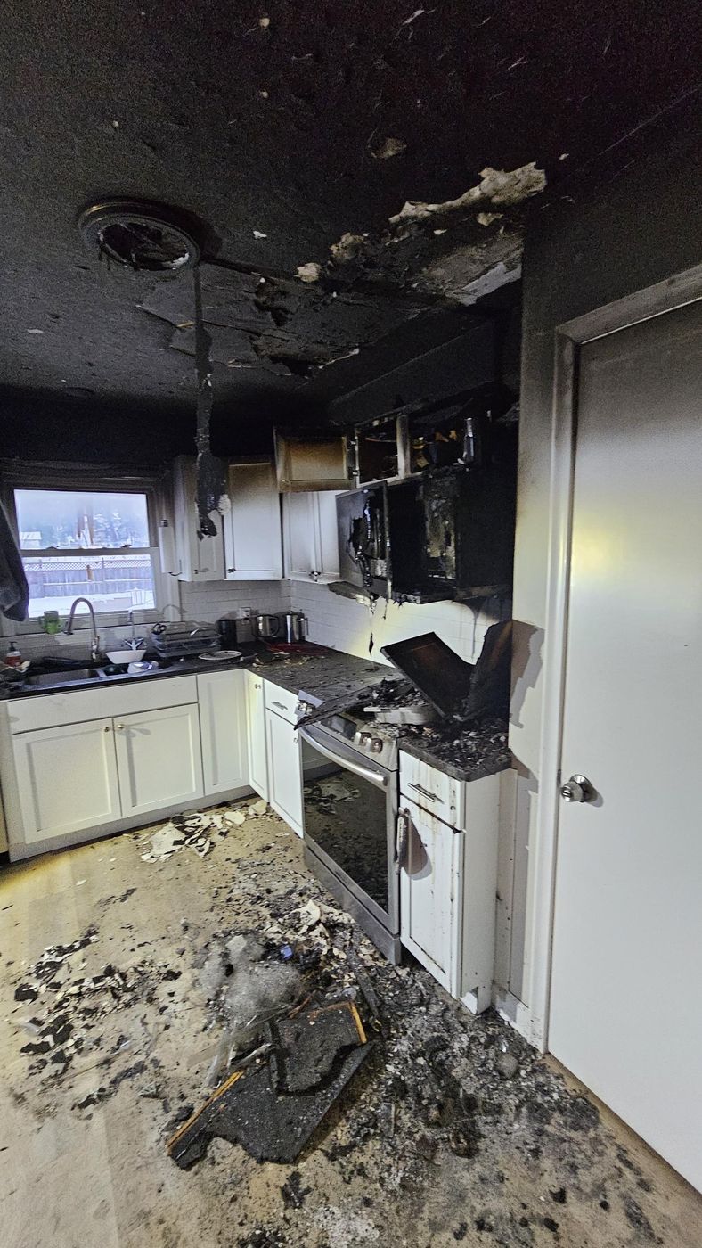 Kitchen fire damage, range and cabinets