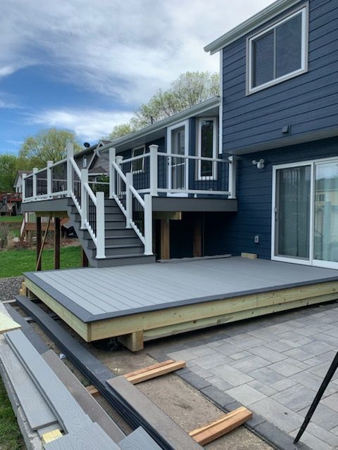Finished composite deck with white railing and stairs